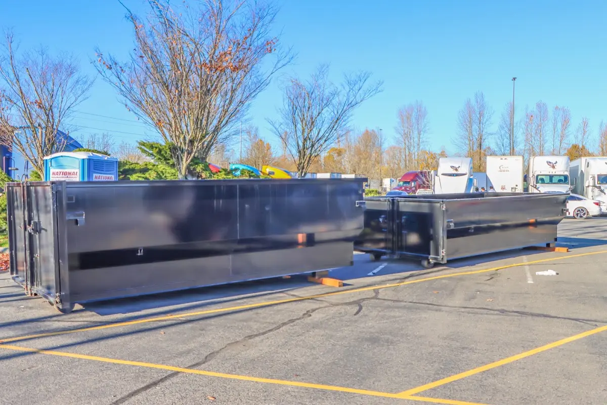 Professional dumpster rental service with roll-off container on residential driveway in South Fulton